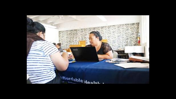 Cinder Sonis, right, an advocate with Legal Aid Society of Hawaii, helped a customer enroll in an Affordable Care Act health insurance plan on Monday, Jan. 30, 2017 in Honolulu. Faced with uncertainty about the federal health care law, Hawaii lawmakers are introducing bills to bring what they believe are the best parts of the Affordable Care Act into state law. (AP Photo/Cathy Bussewitz)
