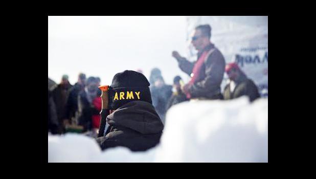An Army veteran attends a briefing for fellow veterans at the Oceti Sakowin camp where people have gathered to protest the Dakota Access oil pipeline in Cannon Ball, N.D., Saturday, Dec. 3, 2016. (AP Photo/David Goldman) An Army veteran attends a briefing for fellow veterans at the Oceti Sakowin camp where people have gathered to protest the Dakota Access oil pipeline in Cannon Ball, N.D., Saturday, Dec. 3, 2016. (AP Photo/David Goldman)