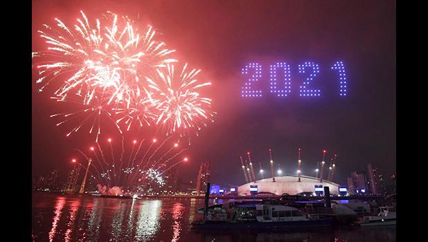 Fireworks and drones illuminate the night sky over London