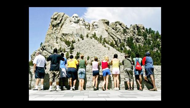 n this July 21, 2005 file photo, visitors watch while workers pressure wash the granite faces of George Washington, left, Thomas Jefferson, Theodore Roosevelt and Abraham Lincoln at Mount Rushmore National Memorial in South Dakota. The Democracy Index, compiled by the London-based Economist Intelligence Unit, ranked the U.S. at 21st worldwide in 2016, tied with Italy and trailing Norway, Canada and Uruguay, among others. While Norway and several other Scandinavian countries are considered "full democracies," according to the index, the U.S. last year fell to "flawed democracy," receiving low scores for "functioning of government" and "political participation." (AP Photo/Charlie Riedel, File) n this July 21, 2005 file photo, visitors watch while workers pressure wash the granite faces of George Washington, left, Thomas Jefferson, Theodore Roosevelt and Abraham Lincoln at Mount Rushmore National Memorial in South Dakota. The Democracy Index, compiled by the London-based Economist Intelligence Unit, ranked the U.S. at 21st worldwide in 2016, tied with Italy and trailing Norway, Canada and Uruguay, among others. While Norway and several other Scandinavian countries are considered "full democracies,
