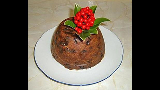 Christmas steamed pudding on a white plate