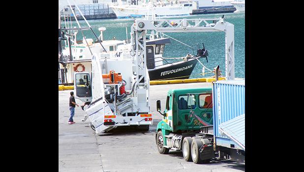 A truck with a container, prepares to go through the container scanner at the main dock around 2:30p.m Friday, Mar. 24, 2017 in Pago Pago, American Samoa. ASG Treasury says the container scanning fee of $200 per container of 20 foot and over, goes into effect Apr. 3. [photo: Fili Sagapolutele]