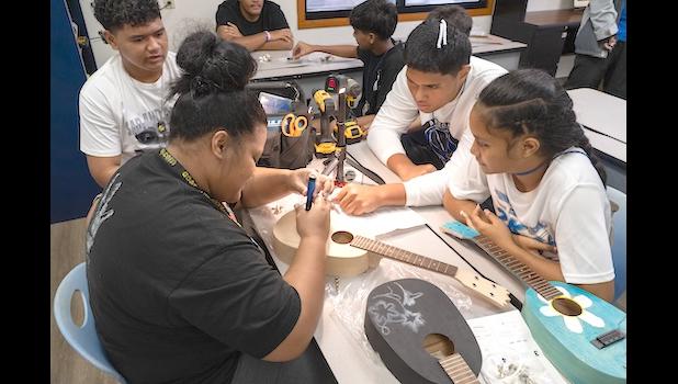 Irene assists BGCAS Music Club members learn how to string their ukuleles.