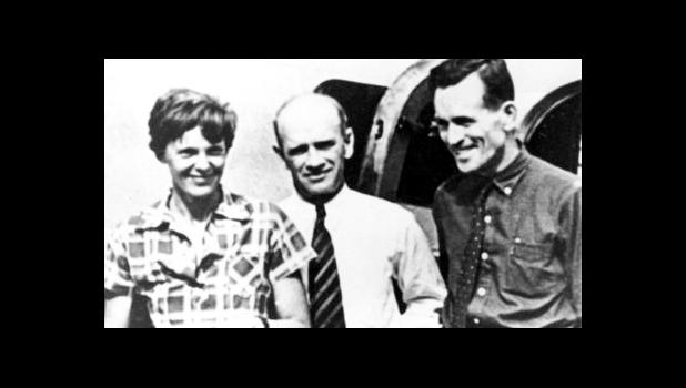 In this file photo taken on or about July 2, 1937, American aviator Amelia Earhart, left, and her navigator, Fred Noonan, right, pose beside their plane with gold miner F.C. Jacobs at Lae, New Guinea just before Earhart and Noonan took off in a flight to Howland Island on July 2, during which they disappeared somewhere in the Pacific. (AP Photo, File) In this file photo taken on or about July 2, 1937, American aviator Amelia Earhart, left, and her navigator, Fred Noonan, right, pose beside their plane with gold miner F.C. Jacobs at Lae, New Guinea just before Earhart and Noonan took off in a flight to Howland Island on July 2, during which they disappeared somewhere in the Pacific. (AP Photo, File)