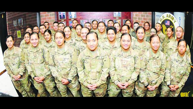 More than 30 members of an American Samoa family pose for pictures Nov. 8 at Thompson Hall. The Soldiers are advanced individual training students and most are enrolled in the Unit Supply Specialist Course taught by the Quartermaster School. In all,, there are 41 members of the same Samoan family training at Fort Lee. [Photo: Terrance Bell]