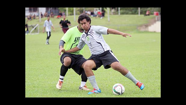 Tea Siatu’u of Utulei Youth in action against Ilaoa & To’omata opponent Shane Ah Hing in a men’s game on Match Day 5 of the 2016 FFAS National League on Saturday, Sept. 17, 2016 at Pago Park Soccer Stadium.  [FFAS MEDIA/Brian Vitolio] 