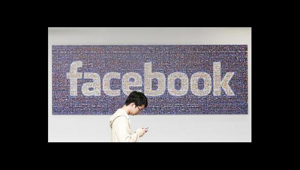 In this June 11, 2014, file photo, a man walks past a Facebook sign in an office on the Facebook campus in Menlo Park, Calif. Facebook announced Thursday, April 6, 2017, it is launching a tool to help users spot false news articles on the site. The tool, similar to others around privacy and security, will be available to users in 14 countries, including the U.S. Users will see it for a few days when they open Facebook. (AP Photo/Jeff Chiu, File) In this June 11, 2014, file photo, a man walks past a Facebook sign in an office on the Facebook campus in Menlo Park, Calif. Facebook announced Thursday, April 6, 2017, it is launching a tool to help users spot false news articles on the site. The tool, similar to others around privacy and security, will be available to users in 14 countries, including the U.S. Users will see it for a few days when they open Facebook. (AP Photo/Jeff Chiu, File)