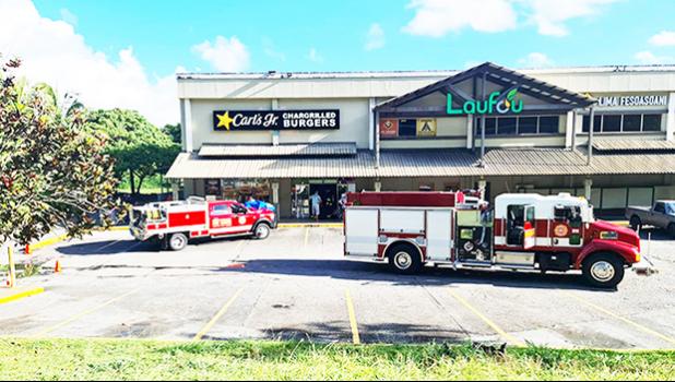 Fire trucks and EMS personnel in front of Carl's Jr