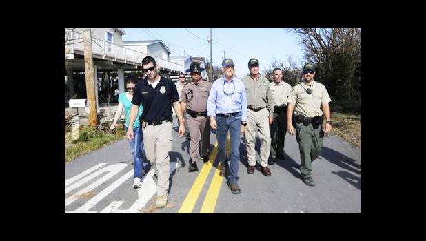 Gov. Rick Scott, center, assess the damages in the aftermath of Hurricane Irma, Wednesday, Sept. 13, 2017, in Big Pine Key, Fla. (AP Photo/Alan Diaz) Gov. Rick Scott, center, assess the damages in the aftermath of Hurricane Irma, Wednesday, Sept. 13, 2017, in Big Pine Key, Fla. (AP Photo/Alan Diaz)