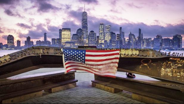 A U.S. flag hanging from a steel girder, damaged in the Sept. 11, 2001