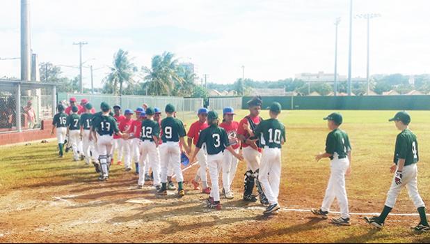  Australia (left) defeated American Samoa 15-0 during the opening match of the U12 Oceania Baseball Championship in Guam yesterday. According to members of the AS Baseball team in Guam, it was a tough game for our young team but the kids did their best. American Samoa played Guam in the second match of the tournament, yesterday. [courtesy photo]