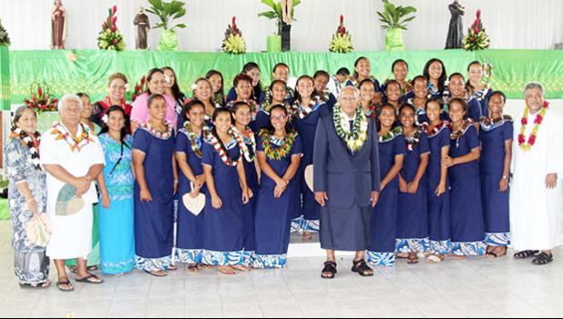 The American Samoa Women’s U-16 team at the Leone Holy Cross Parish with Father Kelemete Pua’auli (far right), Fofo County Senator Faaivae Iuli Alex Godinet (2nd from left), and Sua County Senator Muagututia Tauoa (middle) on Sunday, July 30, 2017.  [FFAS MEDIA/Brian Vitiolio]