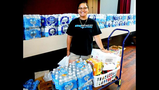 ASCC student Feliciamere P. Elisara, whose Vailoa home was destroyed by Cyclone Gita, receives food, water and clothing during the College’s assistance drive last week for students affected by the cyclone. The ASCC Marketing Committee organized effort, with assistance from the Student Government Association and the College’s student clubs.  [Photo: J. Kneubuhl]