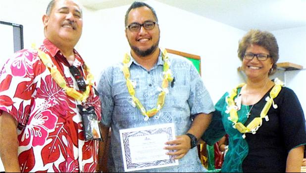 Derek Helsham (center), chairperson of the ASCC Health & Human Services Department, receivimng an award from Vice President Dr. Lina Scanlan, and Agriculture, Community and Natural Resources/Land Grant Director Aufa’i Ropeti Apulu Areta during the College’s Faculty Awards ceremony held at the beginning of the current semester.  [photo: J. Kneubuhl]