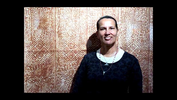 ASCC visual artist Regina Meredith-Fitiao is seen with a large siapo she transported to San Francisco for inclusion in the Mission Cultural Center for Latino Arts exhibit "Deep Blue Sea: String of Pearls," which also featured works by her husband Su'a Tupuola Uilisone Fitiao and a number of west coast artists.   [Courtesy Photo]
