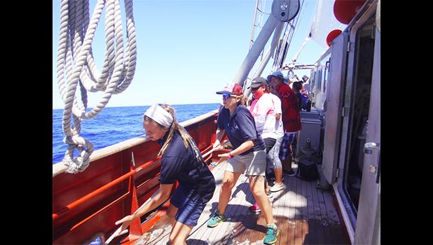During an oceanographic research sail aboard the vessel “Robert C. Seamans,” Sea Education Association staff lead ASCC students in the appropriate line hauling method to raise the main sail, the largest sail on the ship. (Photo. S. Woofter) During an oceanographic research sail aboard the vessel “Robert C. Seamans,” Sea Education Association staff lead ASCC students in the appropriate line hauling method to raise the main sail, the largest sail on the ship. (Photo. S. Woofter)
