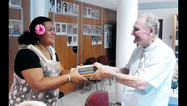 ASCC Samoan Studies Institute Director Mrs. Okenaisa Fauolo-Manila (left) receives a gift of books on the Tahitian language from Bishop Hubert Coppenrath of the Tahitian Academy during the recent Polynesian Festival hosted in Papeete by Te fare Tahiti Nui (also known as the Maison de la Culture).  [Photo: T. Mulitalo-Cheung]