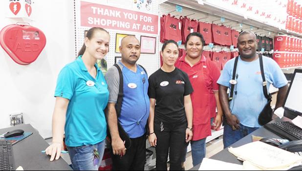 Some of the Neil’s ACE Home Center employees working hard yesterday morning who still managed to smile for the Samoa News camera.  [Photo: EM] 