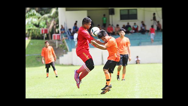 A Black Roses player, left, and Royal Puma opponent, right contest for the ball on Match Day 10 of the 2016 FFAS National League at Pago Park Soccer Stadium on Saturday, Oct. 29.   [FFAS MEDIA/Brian Vitolio]