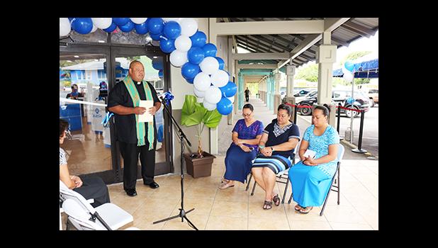 Father Vaiula Kolio blessing the newly renovated Bluesky Communications store at the Laufou Shopping Center, yesterday morning. The inside of the store was ‘blessed’ with Holy Water — which the Catholic priest said, “With the intention that all will be good in the name of our Lord.”  [photo: TG]