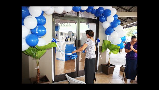 Human Resources Manager Jeannette Yamasaki – one of the longest working employees at Bluesky Communications cutting the ribbon to officially open their newly renovated store, on the ground floor of the Laufou Shopping Center yesterday morning, which also recognized Mrs. Yamasaki’s dedication and service to the company. [photo: TG]