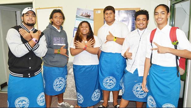 These students volunteered to model, the BugBling, a new “mosquito repellent band” product not yet available in the territory. The mosquito repellant band can be worn on the wrist - as a wrist watch, a person’s ankle (see student model, second from far right) and clipped on a student’s backpack strap (see student model, first from far right.)  [photo: AF]
