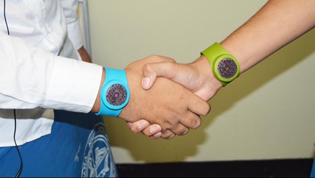 An up close look at the BugBling, a new “mosquito repellant band” worn on the wrist of these two volunteer hand models last Friday afternoon. The product is not available in American Samoa, but there is hope for local acceptance of the product as well as a local distributor.  [photo: AF]