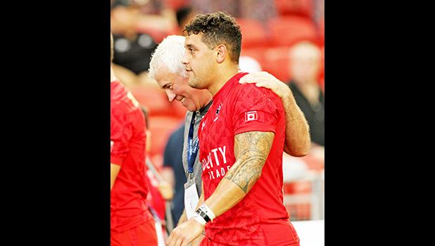 Canada National Coach, Damen McGrath, embraces his Samoan heritage player, Mike Fuailaefau, after a 28-15 thrashing of Russia.  Ironically Coach McGrath is still in litigation with the Samoa Rugby Union for what he believes was an unjust termination.  Singapore Sevens, Day 1, National Stadium, Singapore.  [Photo: Barry Markowitz]