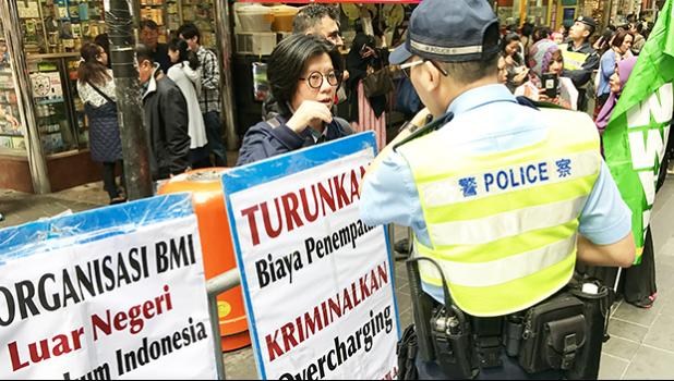 Hong Kong Police oversaw Indonesian domestic workers protesting against working conditions, agent fees in an organized demonstration in Causeway Bay, Hong Kong.  [Photo: Barry Markowitz]
