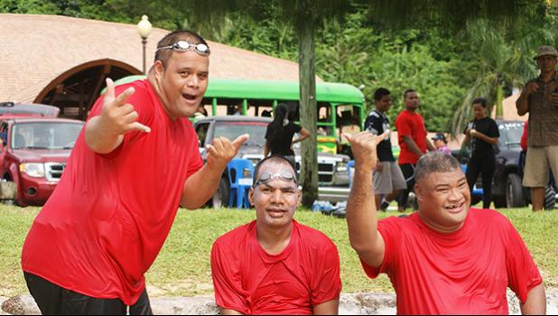 Three athletes with special needs excitedly pose for the camera after racing in one of the heats of the first adaptive aquatic Swim Meet in American Samoa held last Saturday in Utulei.  [Photo: Ese Malala]