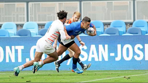 Darren Kellet Moore busts thru two England 7s players to score the second try for Manu Samoa, at the SiliconValley 7s, San Jose, California, USA.  [Photo: Barry Markowitz]
