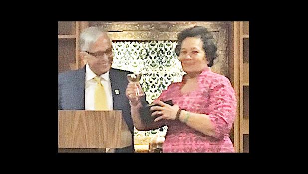 University of Guam president, Dr. Robert Underwood presenting Congresswoman Aumua Amata with the 2017 Distinguished Alumnus Award.  [photo: courtesy]