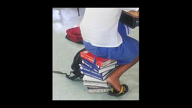 The Samoa News ‘photo of the year’ came from Facebook and was published on Jan. 22, 2016. The photo posted by a parent, asked the question: “The faipule are asking for a salary raise again, but what about this issue?” It points to a student sitting on books, as the lack of chairs and desks for students has been a sore point with the parents of many schools in the territory. [SN file photo]