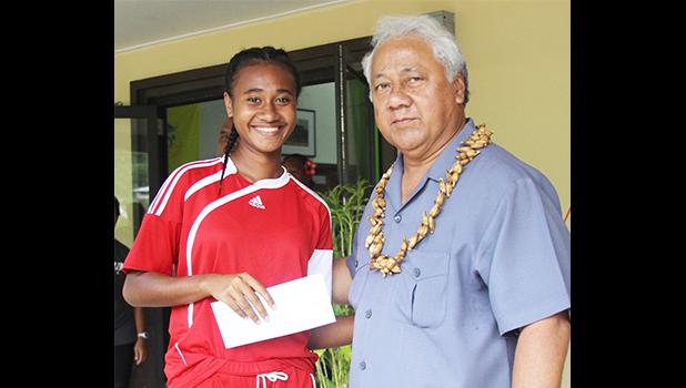 Elcy Lui, left, of Vaiala Tongan’s 13-15 girls team receives her MVP award for the 2017 FFAS Summer Youth League from Sen. Faiivae Iuli Alex Godinet on July 15 at Pago Park Soccer Stadium. [FFAS MEDIA/Brian Vitolio] 