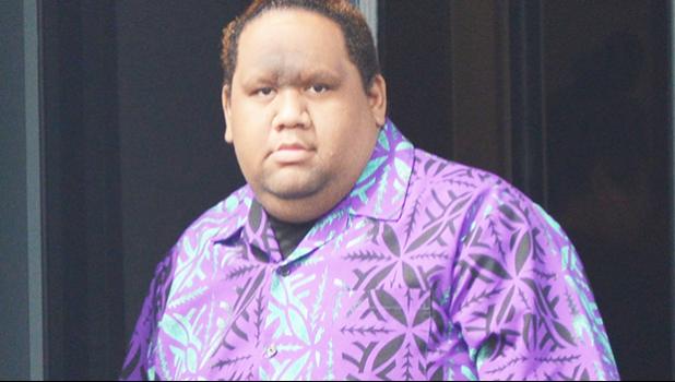 Elijah Jared Tavai exits the front door of the District Court yesterday morning after his initial appearance on 3 criminal charges — child abuse, patronizing prostitution, and endangering the welfare of a child — stemming from an alleged incident involving one of his male students when he was a teacher at Leone High School.  [photo: AF]