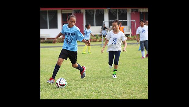 A Kanana Fou 2 player dribbles away from a Pacific Horizons opponent of the 2016 FFAS Private Elementary Schools soccer league’s Grades 3-5 Division on Match Day 2 at the Kanana Fou Seminary Field on Thursday, Oct. 20, 2016.   [FFAS MEDIA/Brian Vitolio]