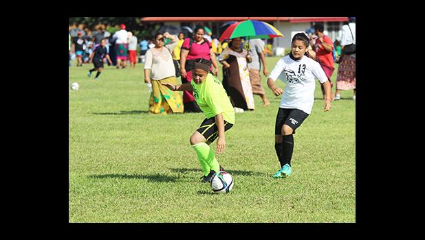 An SPA player, right, and St. Theresa opponent, left, of the Girls 6-8 division in action on Match Day 2 of the 2016 FFAS Private Elementary Schools soccer league at the Kanana Fou Seminary Field on Thursday, Oct. 20, 2016.   [FFAS MEDIA/Brian Vitolio]