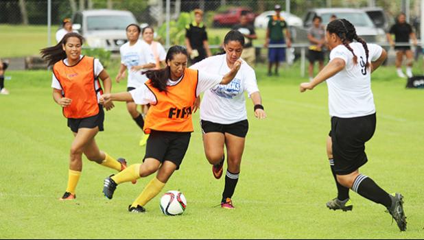 A Fa’asao-Marist Cougars player tries to dribble away from a Samoana Sharks defender in an ASHSAA Girls Soccer J-V game on Saturday, Jan. 21, 2017 at Pago Park Soccer Stadium in Pago Pago.  [FFAS MEDIA/Brian Vitolio]