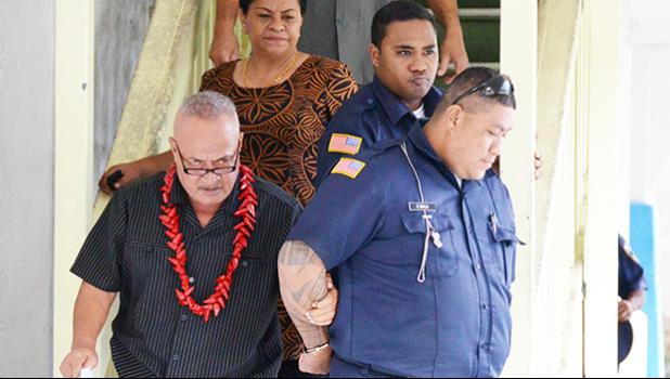 Deputy Commissioner Falana’ipupu Ta’ase Sagapolupele (left) and two other police officers escorting Police Officer Fa’auma Malo (right) from the DPS Central Station in Fagatogo, to an awaiting police unit, after he was arrested last Friday morning. Malo will make his initial appearance in the District Court today.  [photo: courtesy]