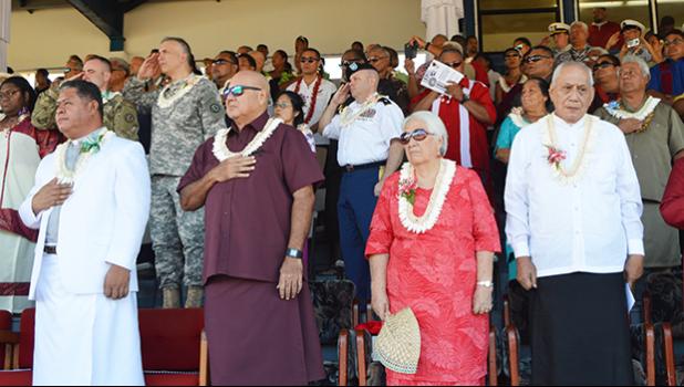 Front row, standing on stage at Veterans Memorial Stadium during the raising of the United States and American Samoa flags at Monday’s 2017 Flag Day ceremony. [l-r] Catholic Deacon  Malaki A. Timu o le the Holy Family Parish Fatuoaiga, Chief Justice Michael Kruse and Masiofo Filifilia Tamasese with Samoa Head of State Tui Atua Tupua Tamasese Efi, who delivered the Flag Day keynote speech. [photo: AF] 0771