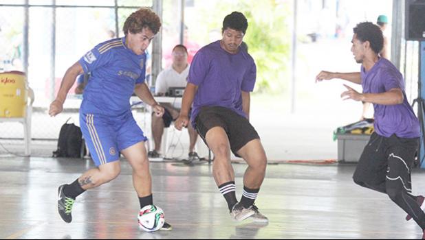 A Green Bay A player dribbles the ball as two PanSa opponents converge on him during Match Day 3 of the 2017 FFAS Futsal Tournament at Samoana High School’s gym in Utulei on Saturday, May 20, 2017.   [FFAS MEDIA/Brian Vitolio]