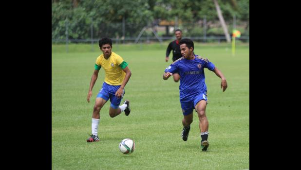 Green Bay’s Pamata Punefu, right, dribbles against Vaiala Tongan’s Mahonri Lotulelei in a men’s game on Match Day 5 of the 2016 FFAS National League on Saturday, Sept. 17, 2016 at Pago Park Soccer Stadium.  [FFAS MEDIA/Brian Vitolio] 