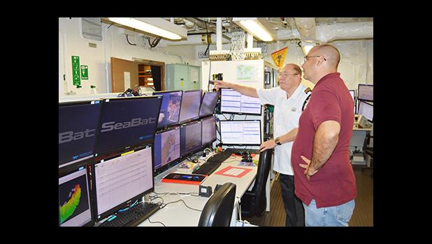 On board the Research Vessel (R.V.) Geo Resolution is Capt. Mike Rowland Hill (right) explaining to ASTCA marketing manager Jason Pritchard features of the vessel, which arrived in port yesterday to conduct a marine survey of territorial waters to lay the new undersea fiber optic cable Hawaiki. ASTCA have signed on to Hawaiki cable.  [photo: AF]