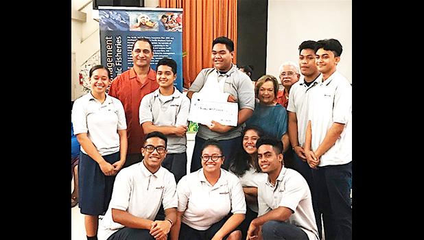 Pictured are the students from Manumalo — with their $600 check — along with one of American Samoa's three members on the Council, Taotasi Archie Soliai, and Dept. of Marine and Wildlife Resources director Va'amua Henry Sesepasara. [photo: BC]