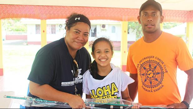 NMSAS education and outreach coordinator Isabel Gaoteote presents a fishing rod to one of the winners of this year's Tautai Fagota Fishing Derby in Vaitogi. See story for full details.  [photo: BC]