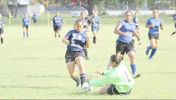 Rapiel Fa’ata’a (#4) of SPA dribbles inside Samoana’s penalty area while the Sharks’ goalie Mele Tialavea slides in for a save in a 2016-17 ASHSAA Girls Soccer playoff game at Pago Park Soccer Stadium on Monday, March 20, 2017. SPA, ranked #3, won the game in penalty shootout against the No 2 ranked SHS. The championship title game is set to kick off today at 4:00 p.m., to be followed by a short awards ceremony.  [FFAS MEDIA/Brian Vitolio]
