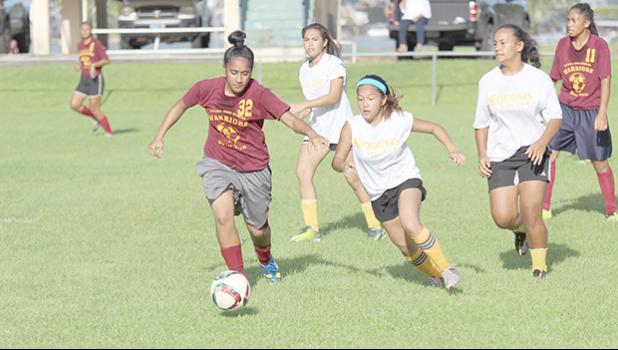 A Tafuna player, left, and Fa’asao-Marist opponent, right, in action a 2016-17 ASHSAA Girls Soccer playoff game at Pago Park Soccer Stadium on Monday, March 20, 2017.  [FFAS MEDIA/Brian Vitolio]
