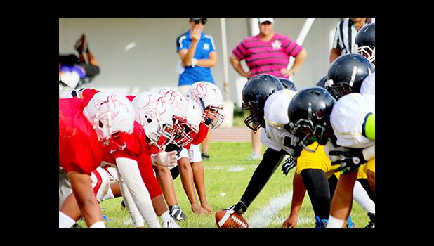 Nu’uuli Wildcats offense, moments away from snapping the ball against a hungry and vicious Faga’itua Vikings defensive front – Faga’itua played the Wildcats to record their second win of the season after a 31 - 14 victory.  [photo: TG]