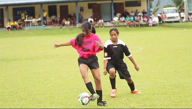 A Tafuna Jets player receives a pass as a Black Roses opponent defends during a game of the women’s 2017 FFAS National League on Saturday, Sept. 23 at Pago Park Soccer Stadium.   [FFAS MEDIA/Brian Vitolio]