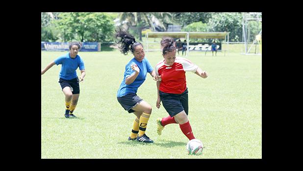 Vasati Makiasi, right, of the Tafuna Jets dribbles past a Royal Puma defender, during the women’s FFAS National Cup game on Match Day 9 of the 2016 FFAS National League at Pago Park Soccer Stadium on Saturday, Oct. 22, 2016.  [FFAS MEDIA/ Brian Vitolio]